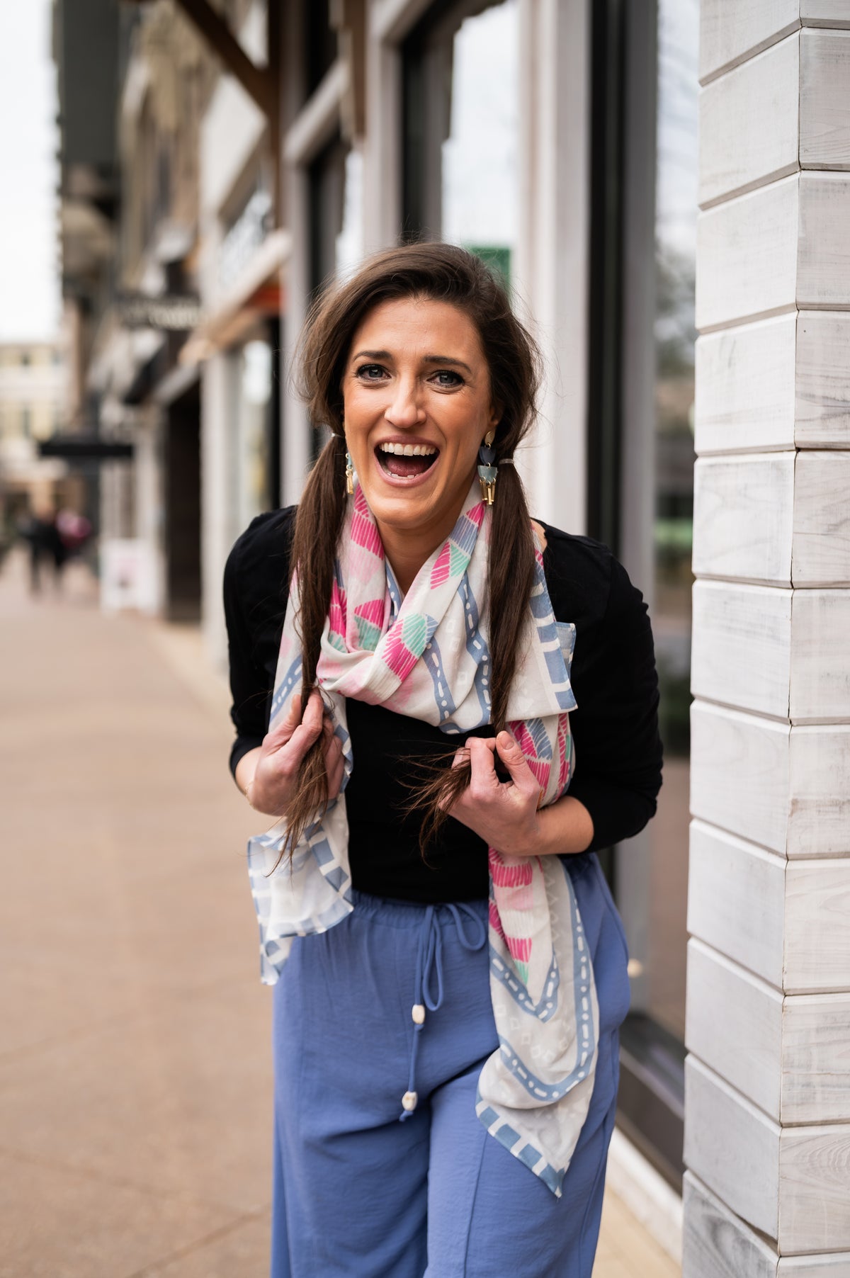A woman laughing in a CB Grey silk scarf