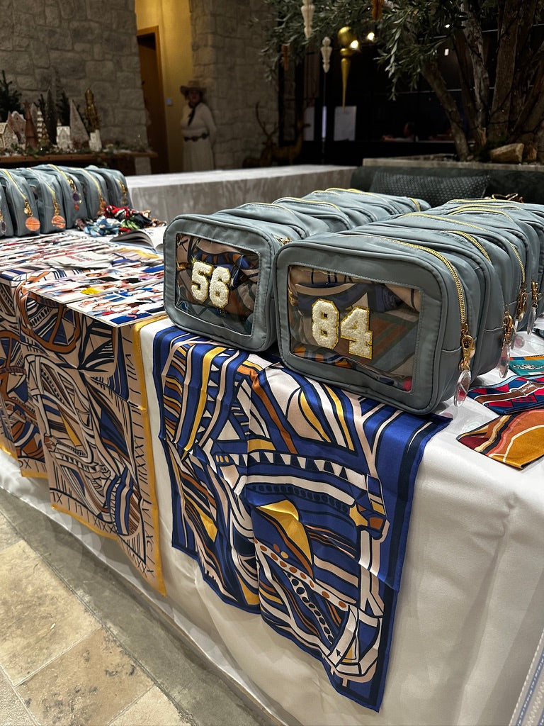 The custom silk and personalized pouches set up at the Rams Women Christmas party
